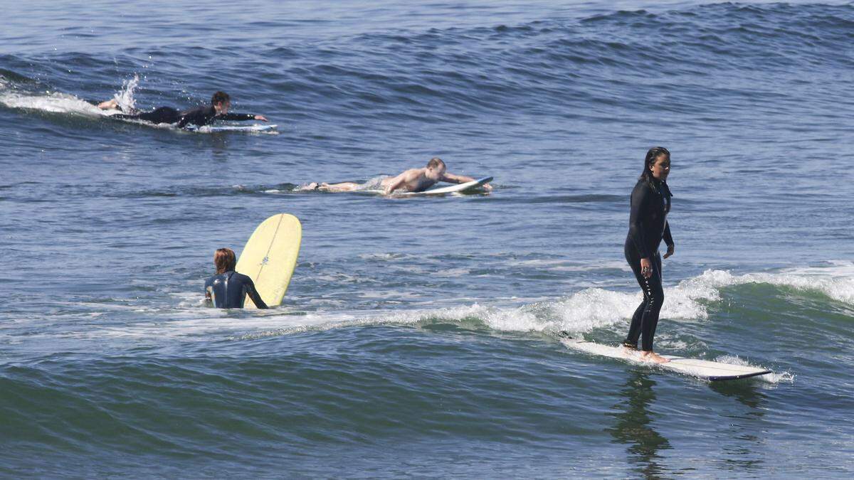 At least one surfer took to the March waves north of Morro Rock without the customary wetsuit. Warm temperatures continue as heat records are threatened on March 18, 2026.