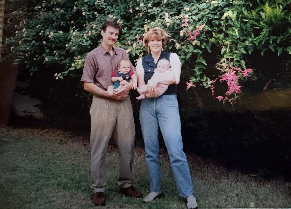 Susan Miller, retired CIA agent and Cal Poly grad, stands with husband, Andy. The two are holding their 6-week-old twins after first landing in Israel in 1998.