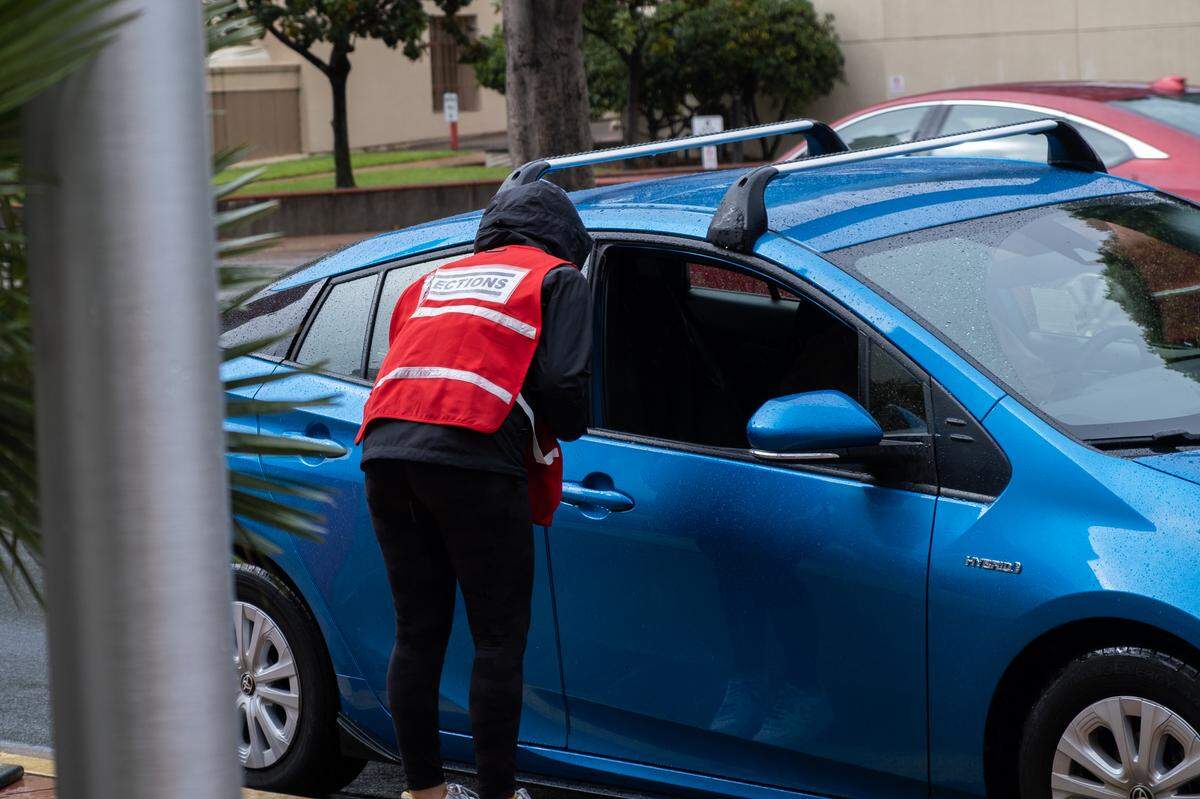 A voter drops off thier ballot at the San Luis Obispo County Government Center drive-thru drop-off location in downtown San Luis Obispo on Nov. 8, 2022.