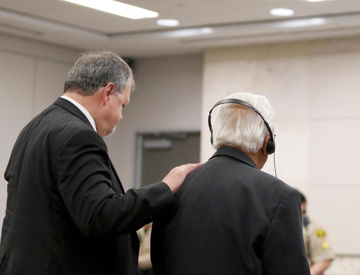 Defense attorney Harold Mesick, left, puts his hand on the shoulder of his client, Ruben Flores, after the jury acquitted Ruben Flores of charges of accessory to murder after the fact. The jury’s verdict was read in Monterey County Superior Court on Oct. 18, 2022.