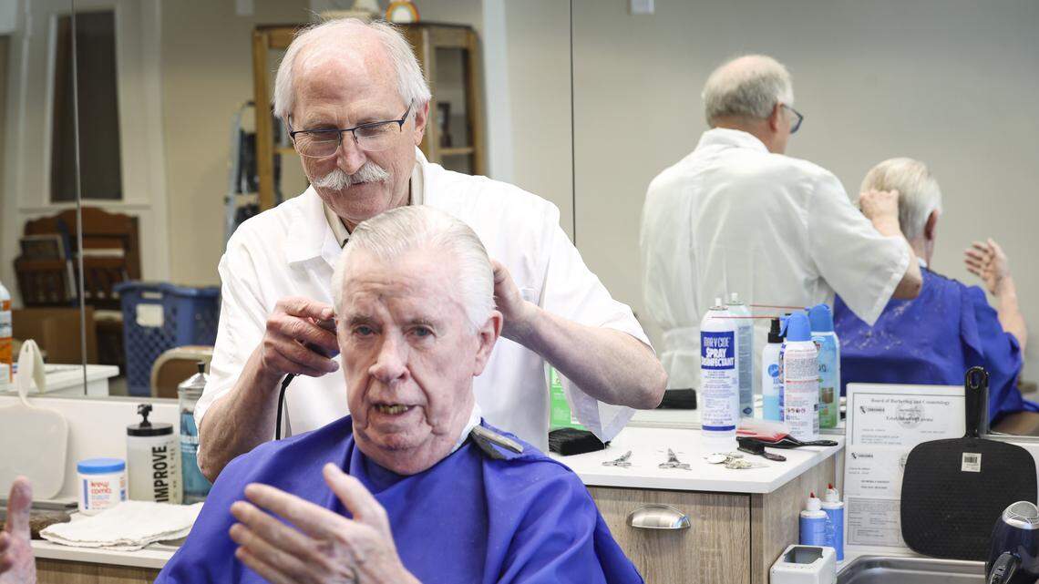 Barber Ray Shearer swaps stories with Terry O’Farrell. The Anderson Barber Shop has moved back to its original location on Monterey Street, seen here on April 7, 2026.