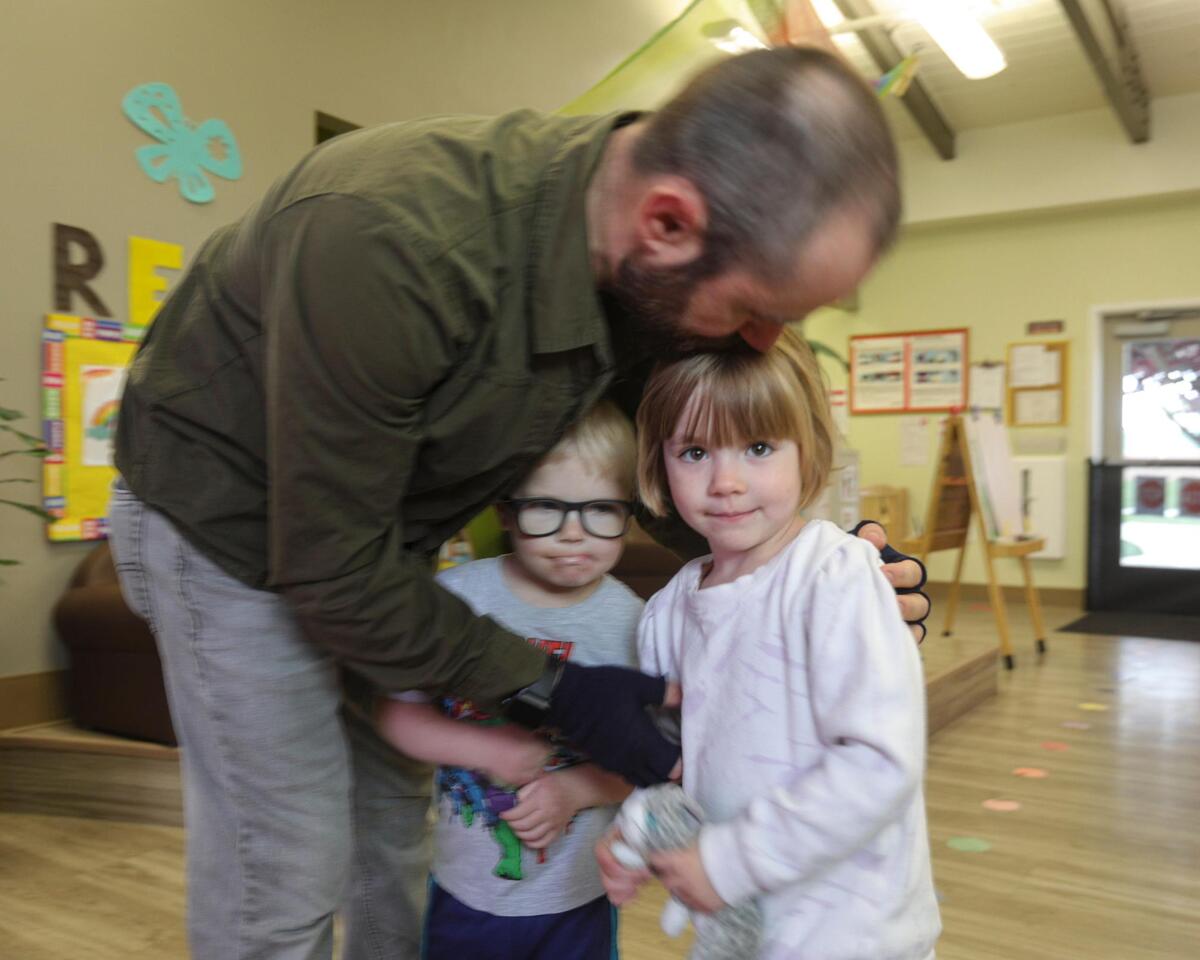 Darrien Lohof gives a hug to kids Lucas and Miranda who are both almost 4 at drop off. They were taking part in the Activities at CAPSLO’s Head Start program in Nipomo on April 25, 2025.