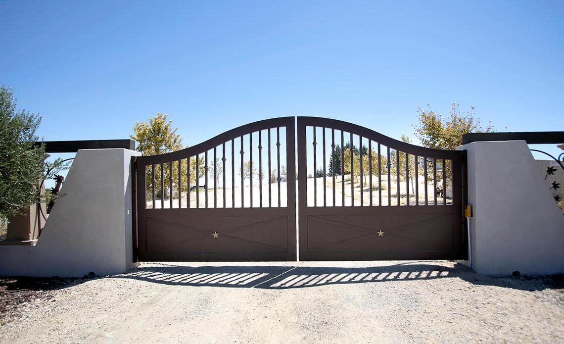 A gate guards the entrance to the San Miguel home of Charles Miller and Tina Gulotta-Miller.