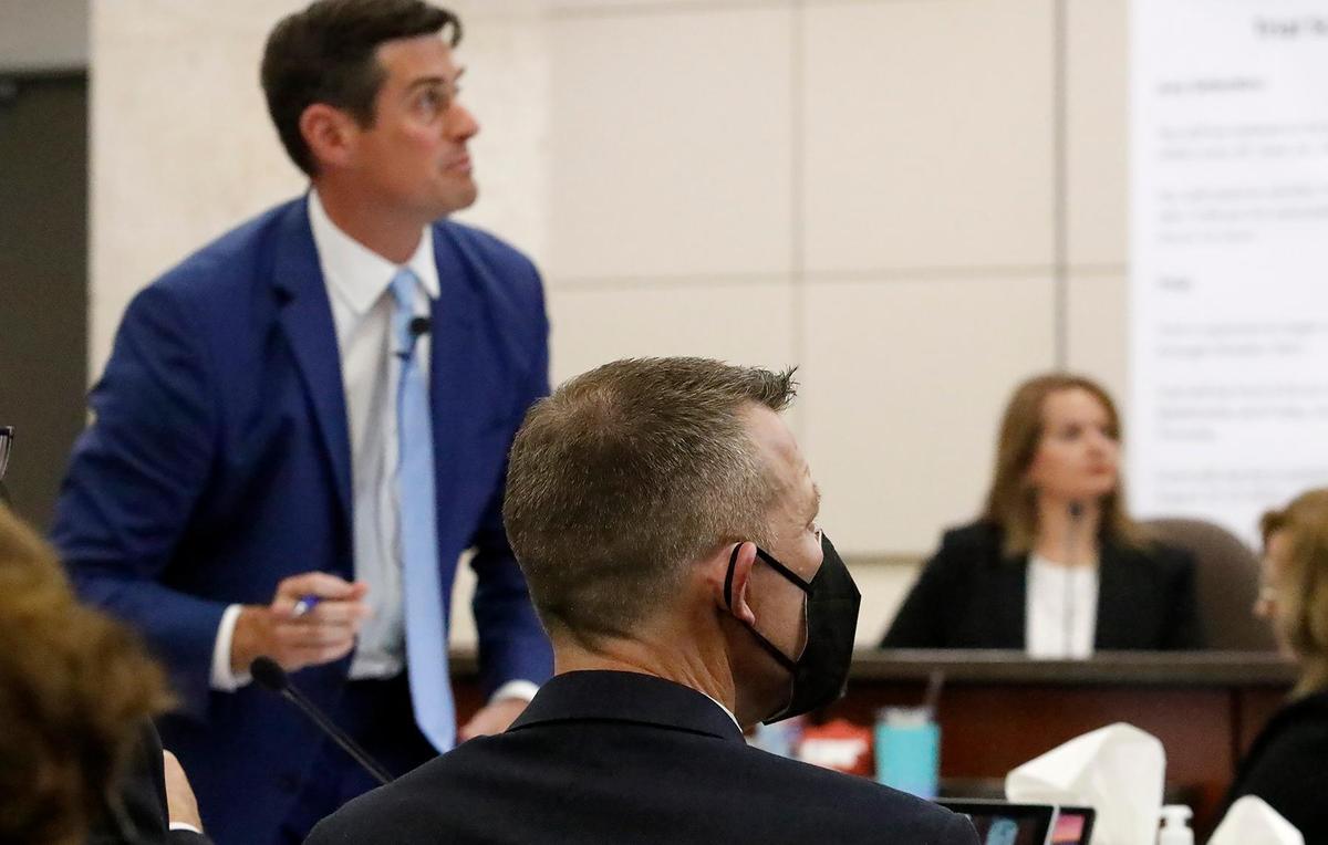 Prosecutor Chris Puervelle places a slide on the projection screen as defendant Paul Flores, foreground, looks on in Monterey County Superior Court in Salinas on Monday, Sept. 19, 2022, during the Kristin Smart murder trial.