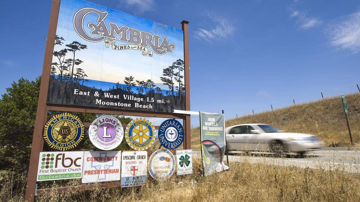 A car whizzes past the Cambria sign on Highway 1 at the south end of town.