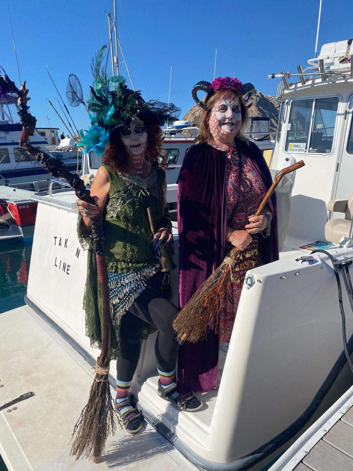 Debbie Ramirez, left, and Paula Hunter show off their costumes at the 10th annual Witches and Warlocks Paddle in Morro Bay on Sunday, Oct. 29, 2023.