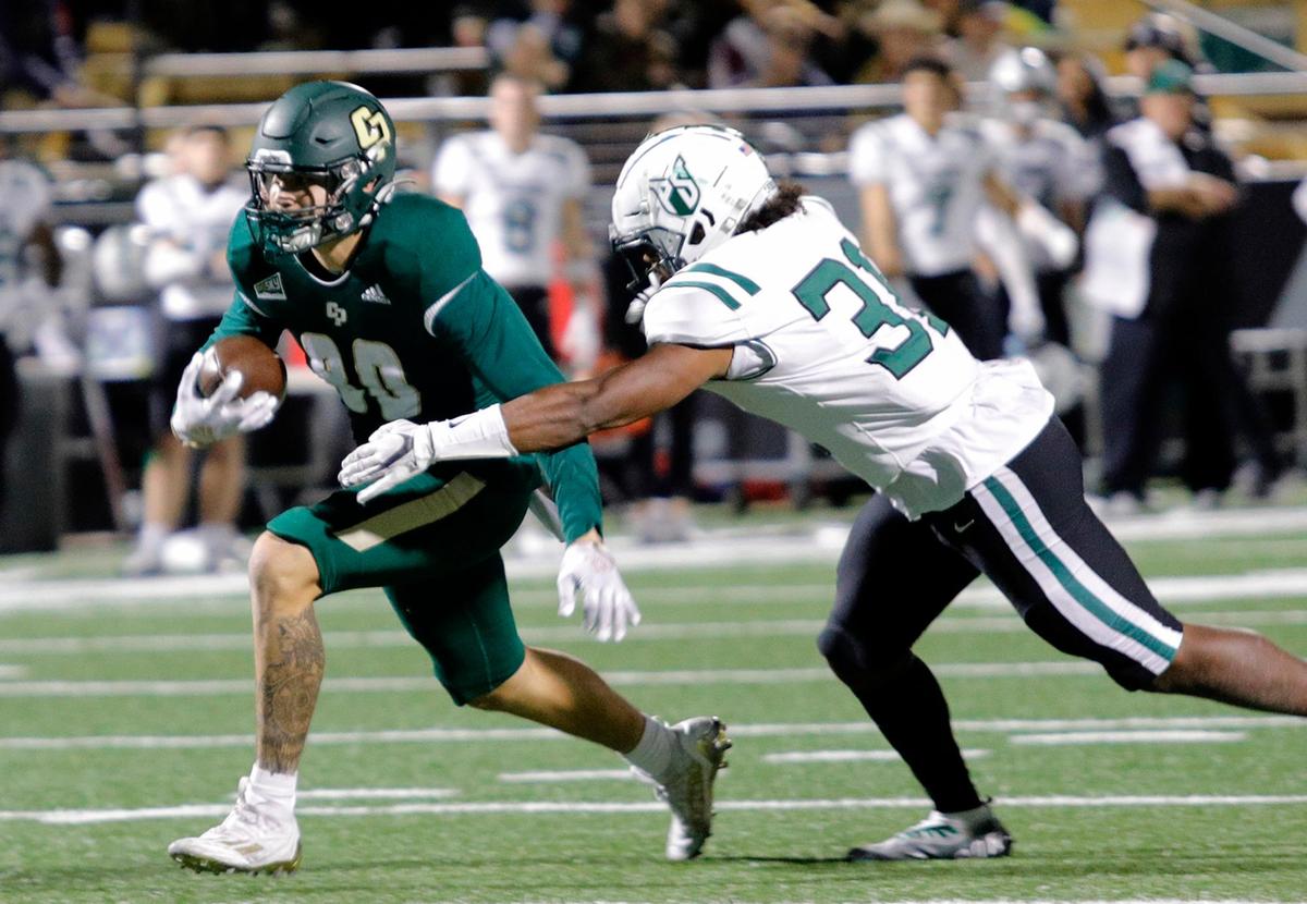 Mustang Josh Cuevas (80) is pursued by Viking linebacker Jaymason Willingham (31). Cal Poly beat Portland State 49-42 to earn their first and only Big Sky win of the season on Saturday, Nov. 19, 2022, at Alex G Spanos Stadium in San Luis Obispo.