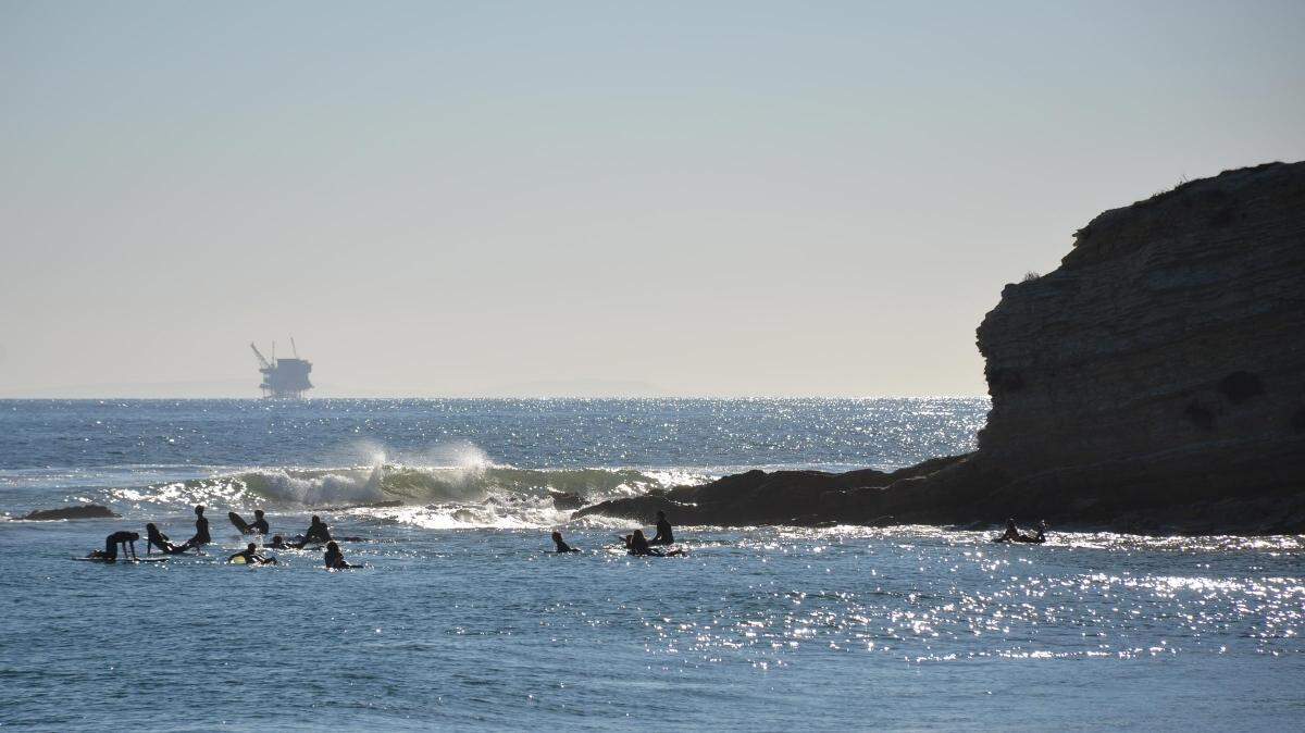 One of ExxonMobil’s offshore oil and gas platforms seen from Refugio State Beach in southern Santa Barbara County. The platforms stopped operating after the transportation pipeline ruptured and caused the 2015 Refugio oil spill. ExxonMobil recently purchased the pipeline from Plains and plans to sell it and its local Santa Ynez Unit to Sable Offshore Corp. (Giana Magnoli