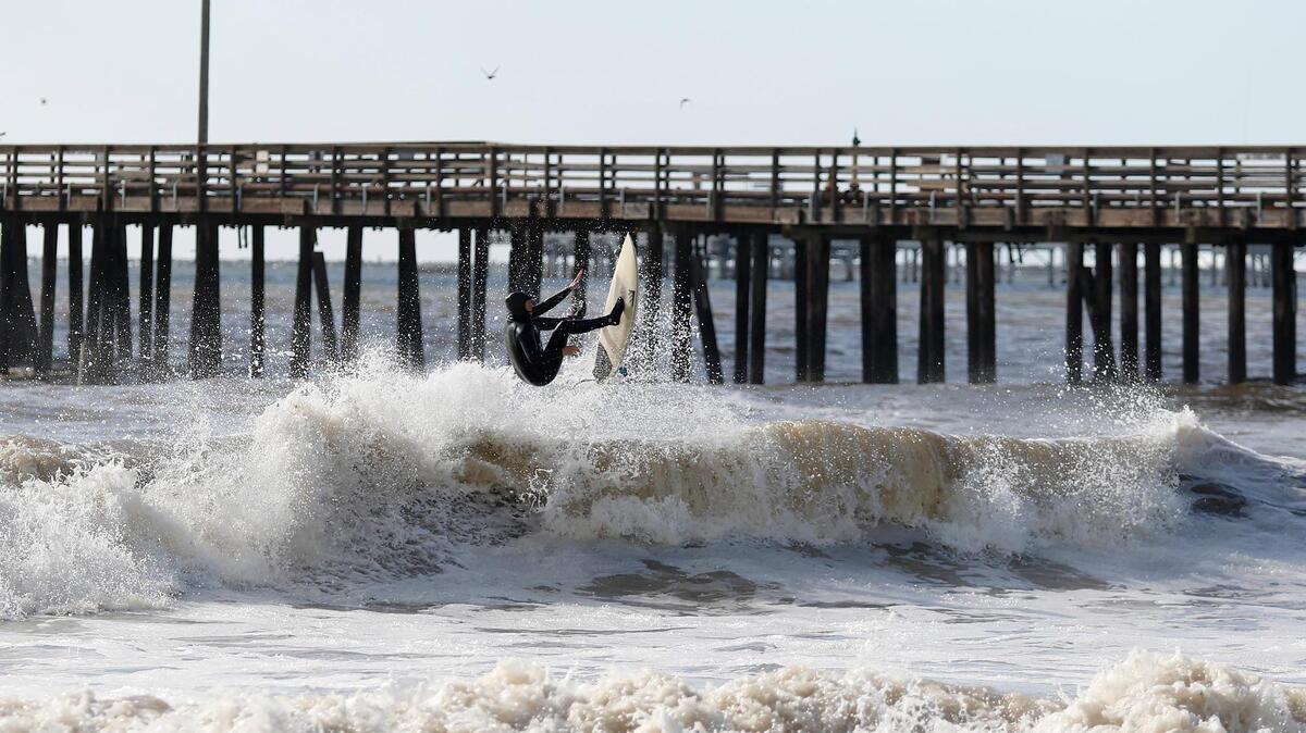 A surfer hits the waves in Avila Beach on Sunday, Dec. 11, 2022, following a powerful storm.