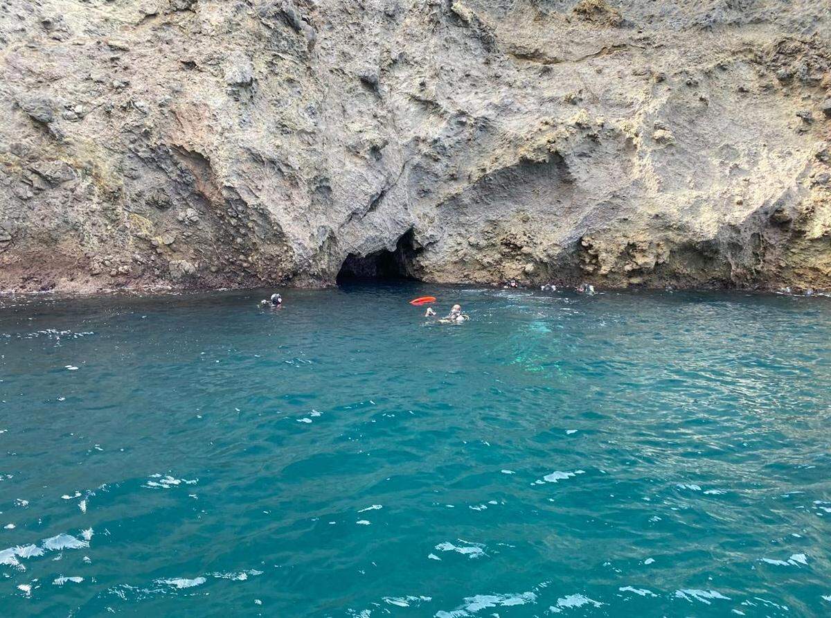 Divers are seen near the mouth of a cave during the recovery of a diver’s body on Friday, Nov. 11, 2022.