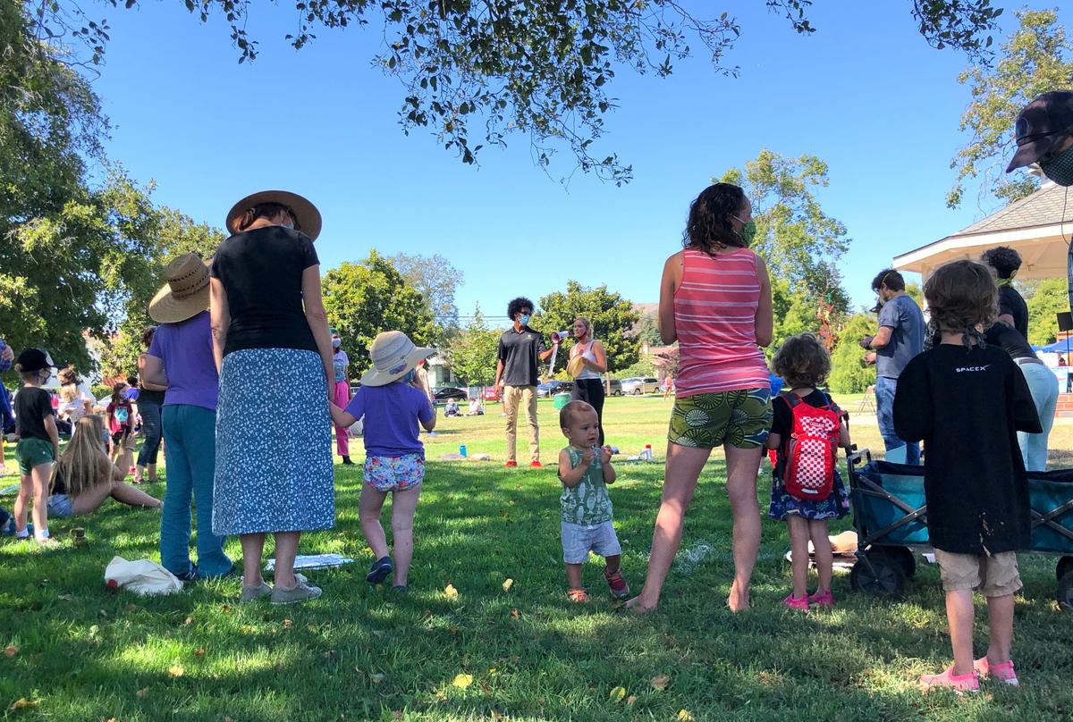 Young children and their parents listen while speakers teach them about race, racism and how to stand up to bullies. Hundreds gathered in Mitchell Park for the event, the Central Coast Children’s March for Black Lives, on Sunday for the educational event followed by a march around downtown.