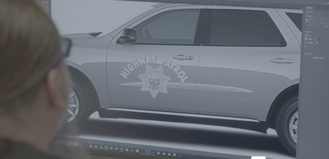 A CHP employee looks at the design of the new low-profile Dodge Durangos entering the agency’s fleet of roadway vehicles.