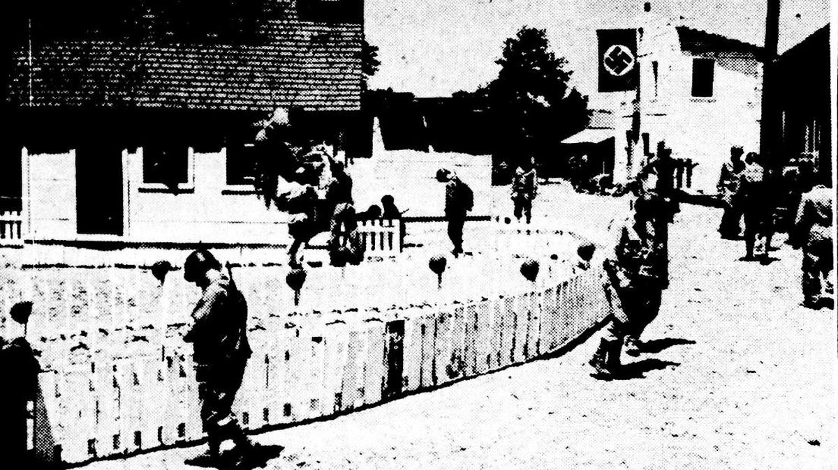 Photo shows a model Nazi village, thoroughly mined, for the purpose of teaching Field Artillery trainees at Camp Roberts all the tricks of the booby trap. Constructed by the Field Artillery center plans and training office, the town is strictly German even to the street signs. Published May 30, 1944.