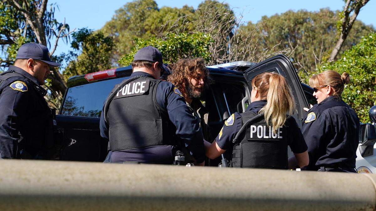 Morro Bay police officers arrest a homeless man who struck an officer during an encampment removal near Highway 1 on Feb. 13, 2024. Morro Bay’s new camping ordinance was approved by the City Council in December 2023 and prohibits camping for more than 24 hours in one location or within specific distances of roads, residential areas and some public property.