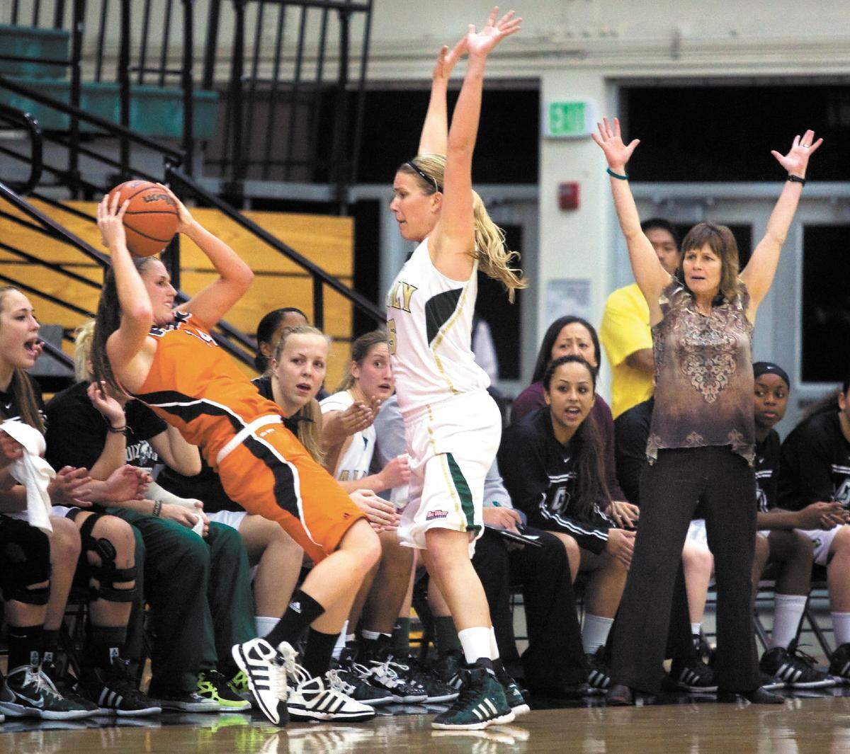Cal Poly’s Christine Martin, center, is called for a foul as Pacific’s Sam Pettinger falls into the Cal Poly bench during a 2012 game at Mott Gym while Mustangs head coach Faith Mimnaugh, right, looks on.