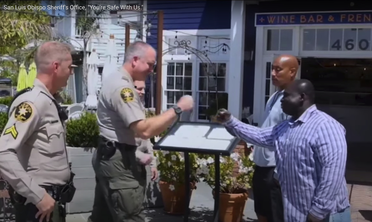 Deputies fist bump for video, “You are safe with us.” In spite of COVID-19 pandemic, no one wore a mask and social distancing recommendations were ignored.