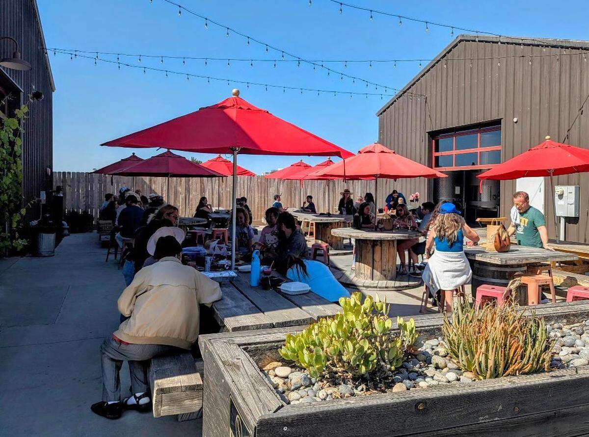 Customers gather on the patio at Tin City Cider Co. during Memorial Day weekend, one of the final weekends before the Paso Robles tap room closed May 24 after nearly a decade in Tin City.