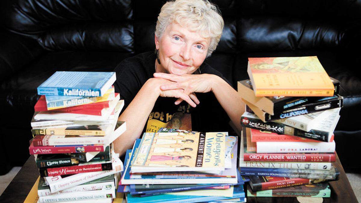 Author Vicki Leon with a stack of books she's written over  the years.
Photo by Joe Johnston 08-17-10
