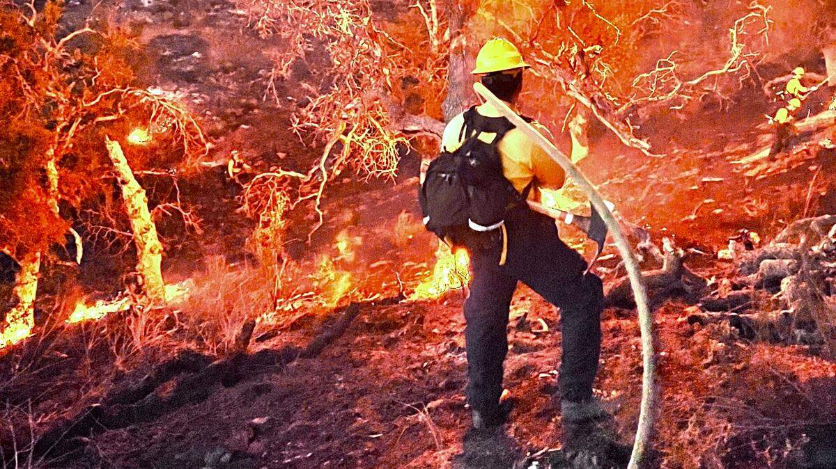 A firefighter battles the Rinconada Fire next to Rinconada Ranch on the north side of Highway 166, halfway between New Cuyama and Santa Maria.