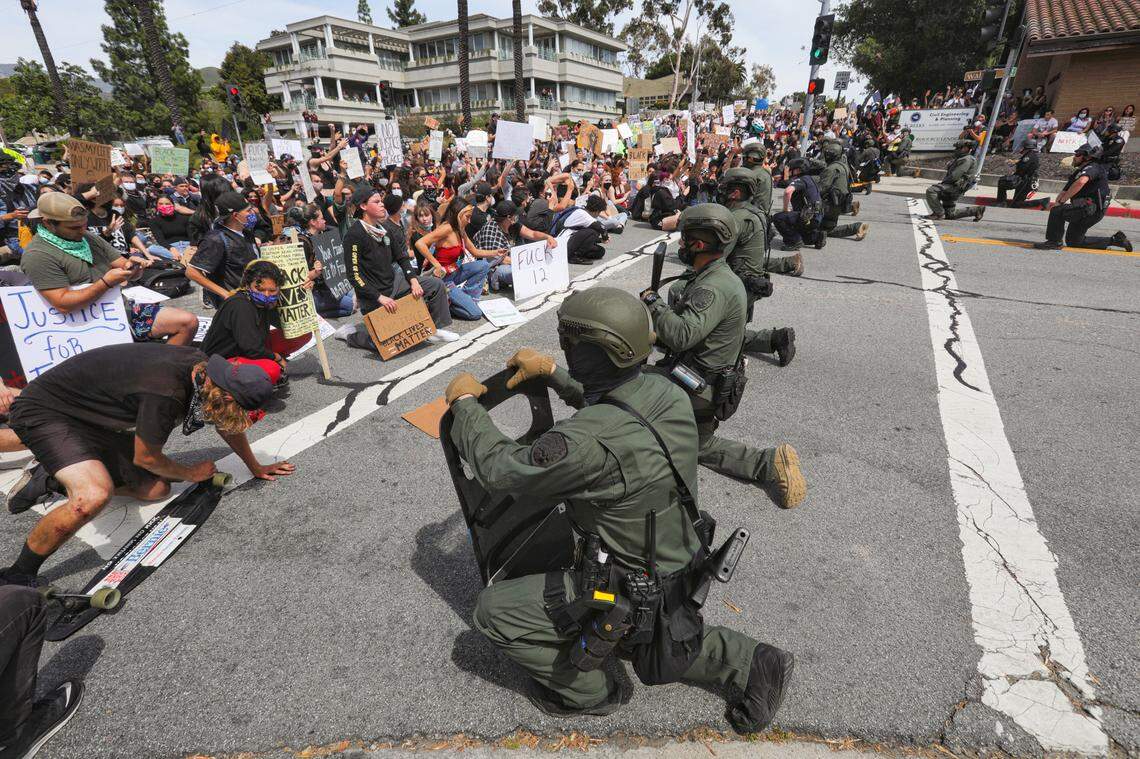 Officers from CMC and the San Luis Obispo Police Department took a knee as protesters held an 8-minute moment of silence on June 1.