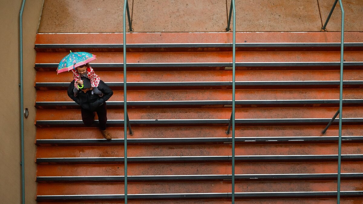 A pair of movie goers head to a show at the Downtown Centre Cinema on Saturday as the first of three storms made landfall, drenching San Luis Obispo County.