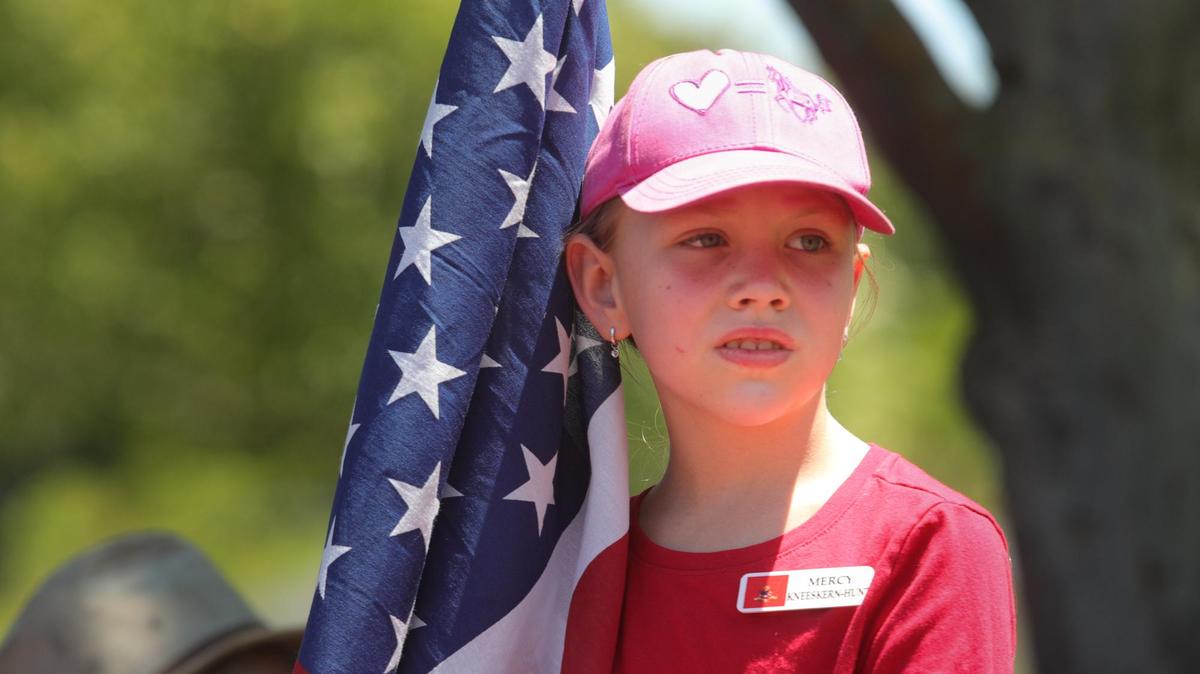 Mercy Kneeskern-Hunt, 9, was one of the flag holders at the entry to Faces of Freedom Memorial in Atascadero for Memorial Day.