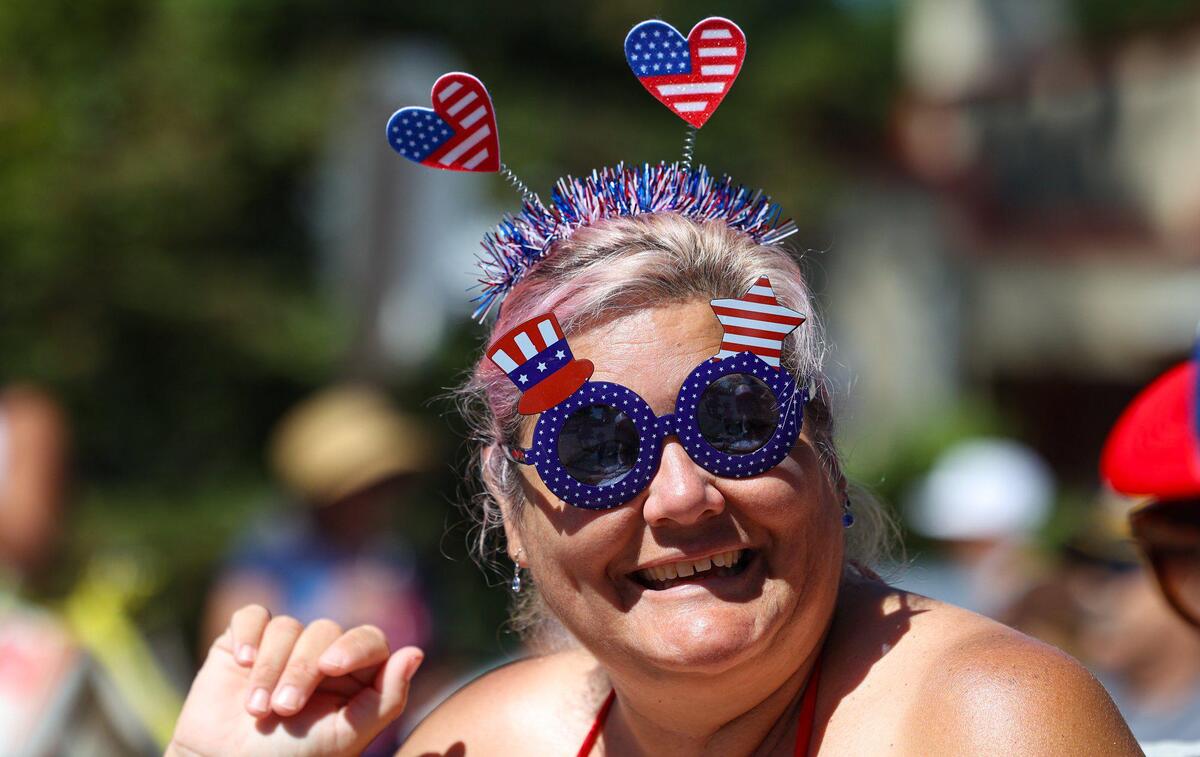 Adrianne Hamers watches the Templeton 4th of July parade through red, white and blue sunglasses on Tuesday, July 4, 2023.