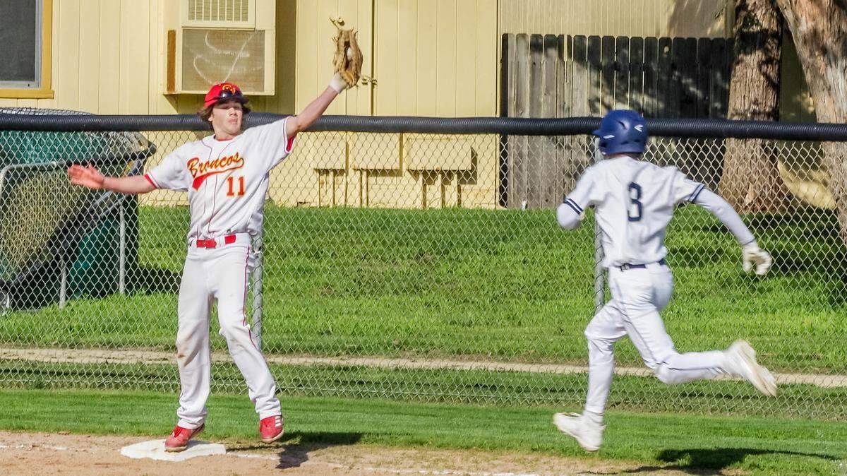 Coast Union High School first baseman Dane Volz reaches to get the runner out against Coastal Christian on April 4, 2023.