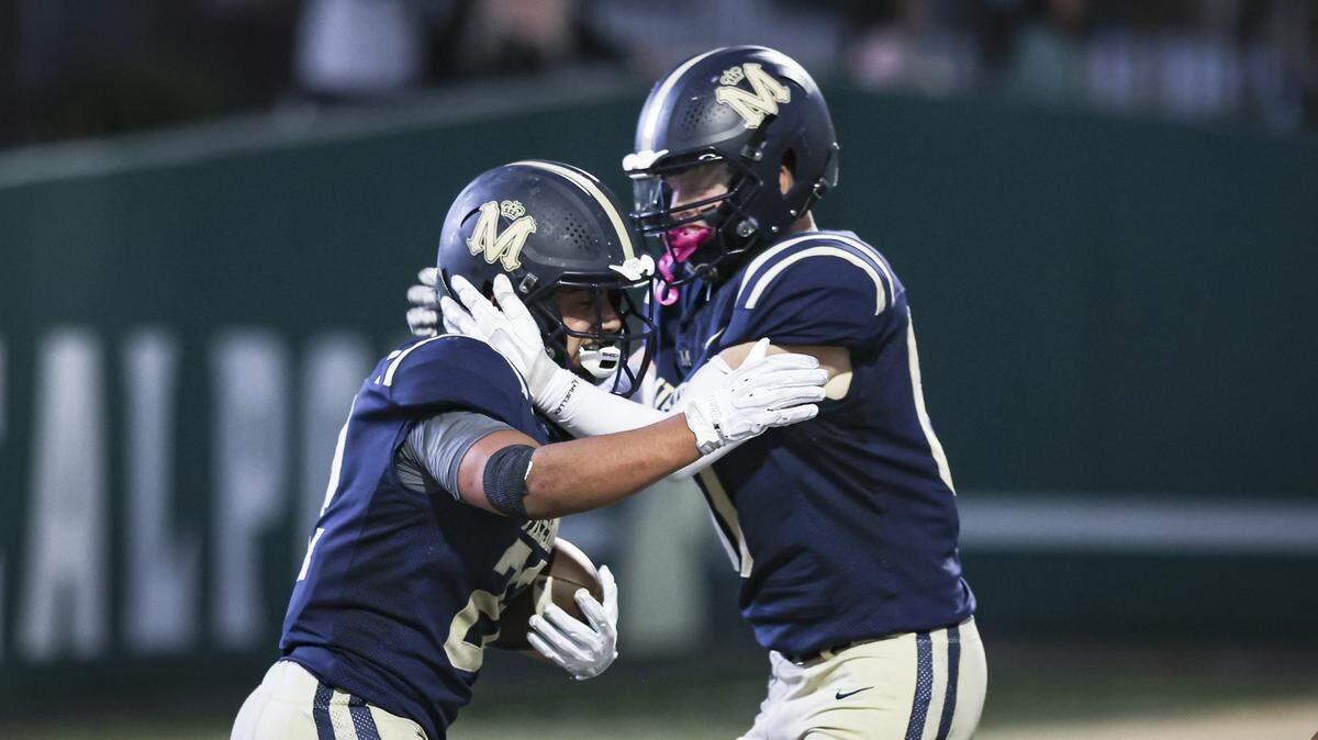 Ronnie Kardashian, left, celebrates a touchdown with Eddie Turrentine. Mission Prep beat Oxnard 22-19 in the first football game of the season on Aug. 22, 2025.