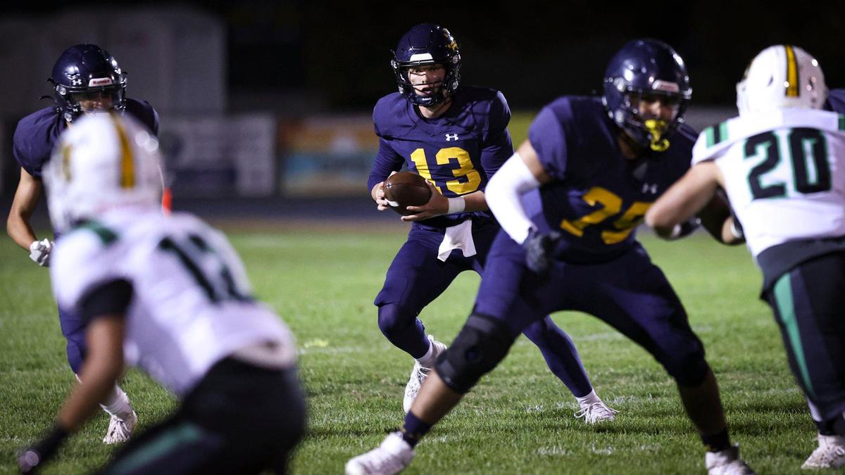 Sam Wulff takes the snap and looks downfield. Arroyo Grande beat St. Joseph 21-6 in a high school football game on Oct. 18, 2024.