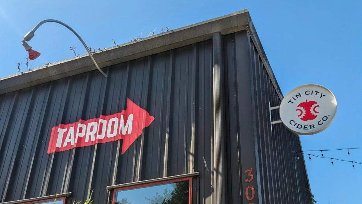 A “Taproom” sign points visitors toward Tin City Cider Co. in Paso Robles’ Tin City district. The longtime cider business closed its tap room May 24 but will continue retail cider sales throughout the Central Coast.