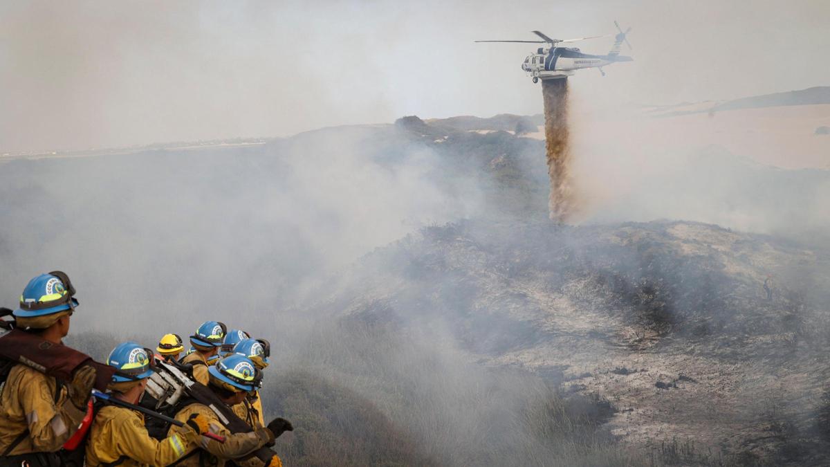 Firefighters battle a stubborn brush fire West of Oso Flaco Lake in the Oceano Dunes on April 21, 2025