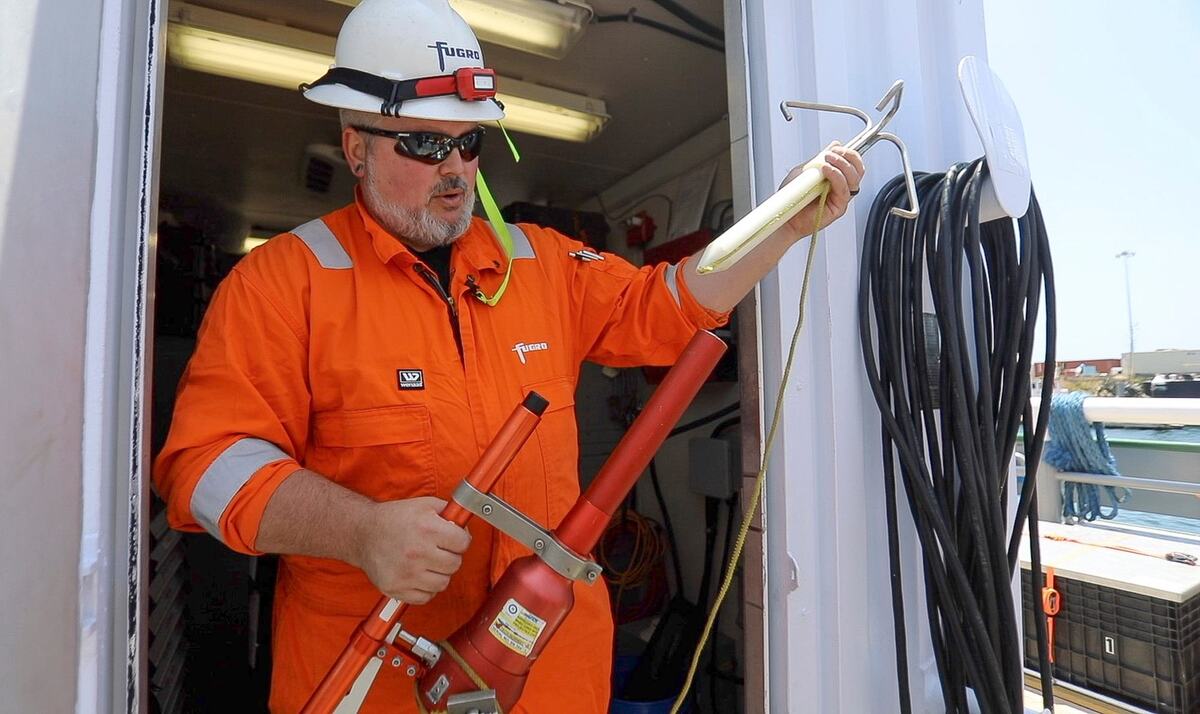 Go Adventurer senior party chief Robert McDowell displays the pneumatic line thrower, which is used to retrieve the autonomous underwater vehicle when it surfaces after completing surveys.