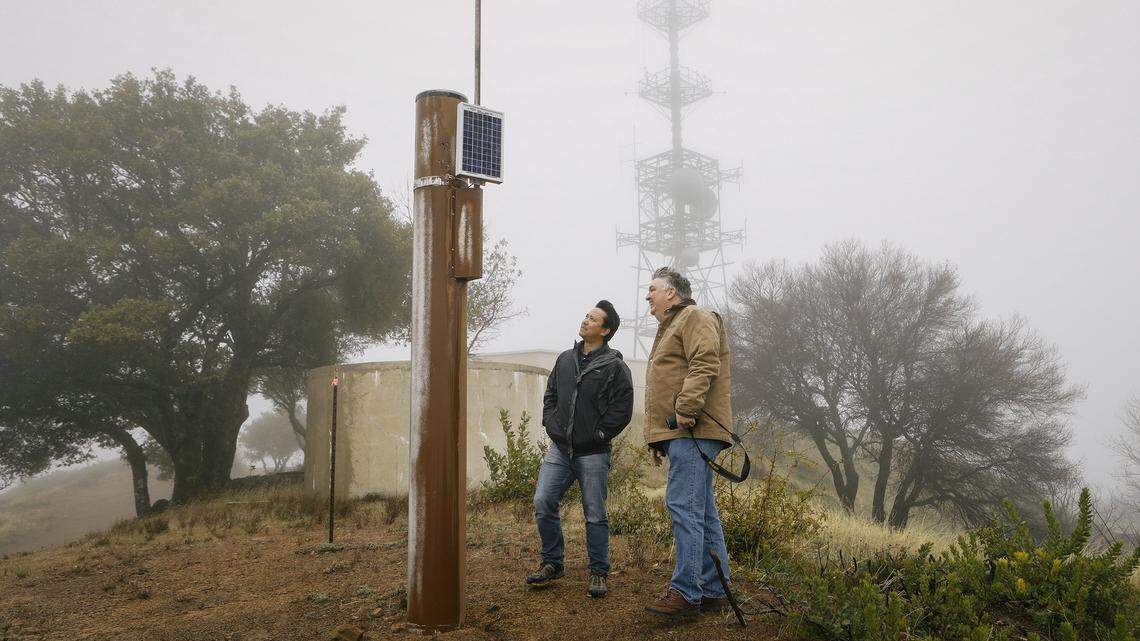 Ray Dienzo of San Luis Obispo County Public Works, left, and PG&E meteorologist John Lindsey look over the Rocky Butte rain gauge on a recent afternoon.