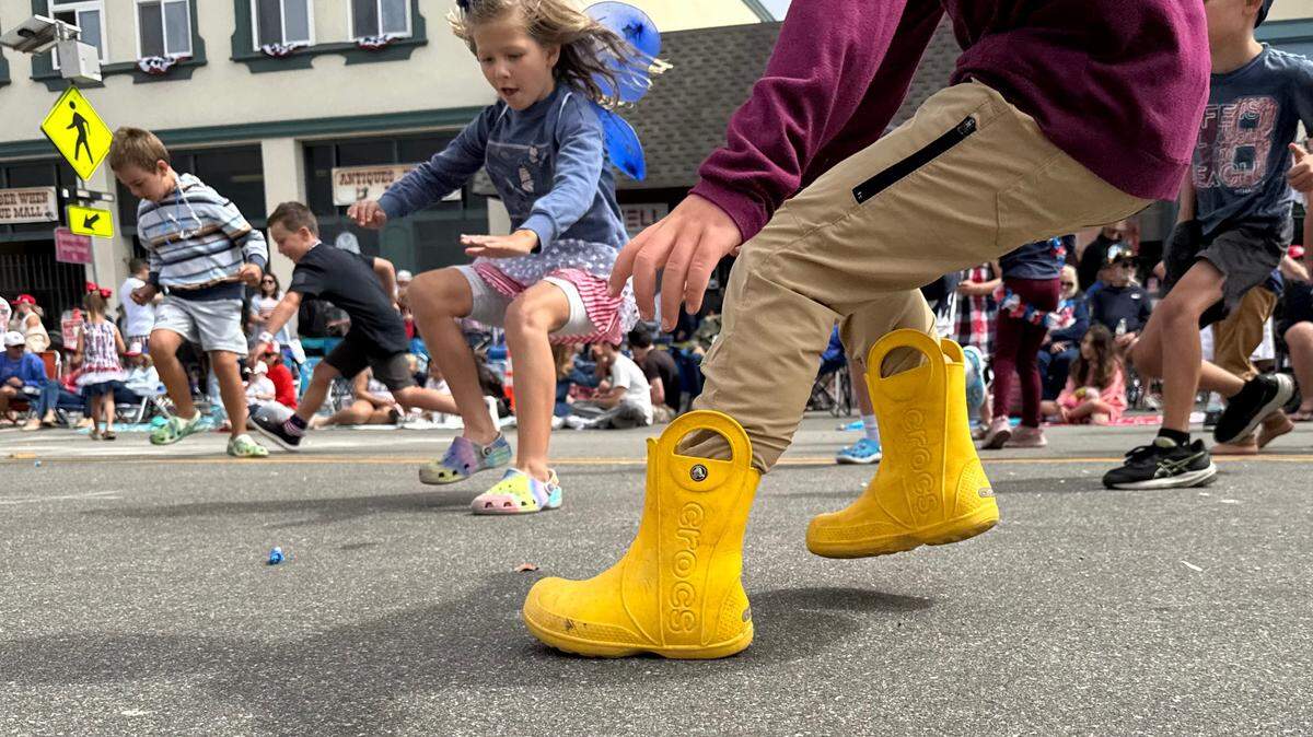 Kids scramble for candy thrown from parade floats at the Fourth of July parade in Cayucos, California. 