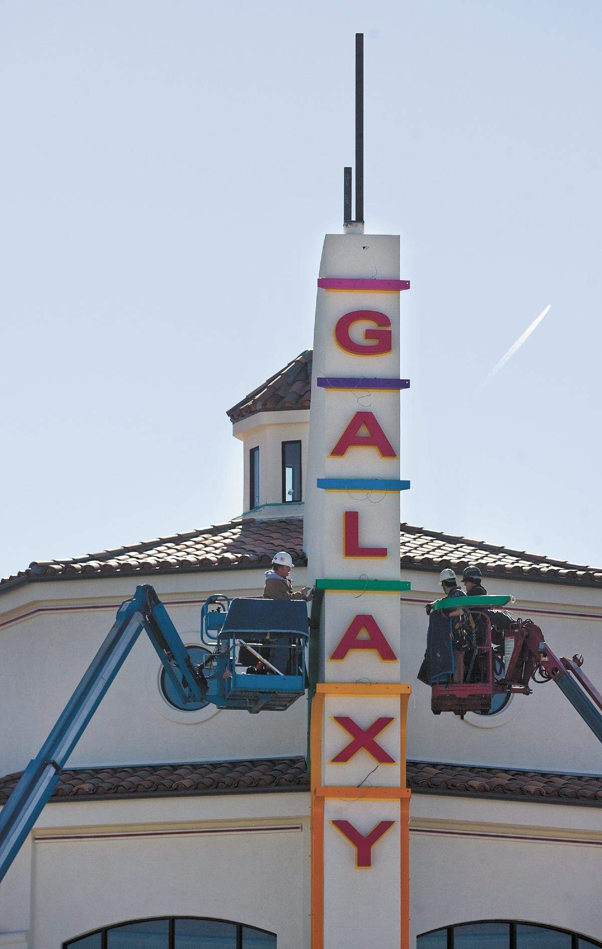 Workers install the Galaxy Theatres sign in Atascadero in June 2013. The theater will be renamed Colony Cinemas as a new operator takes over.
