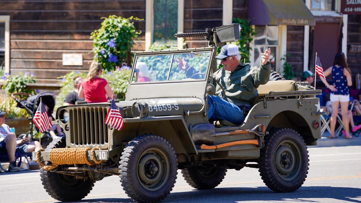A World War II-era combat vehicle driven by the Estrella Warbirds Museum cruises down the street in the Templeton Fourth of July Parade Thursday, July 4, 2024. The parade featured dozens of floats and acts, including classic cars, marching bands and appearances by local law enforcement and fire services.
