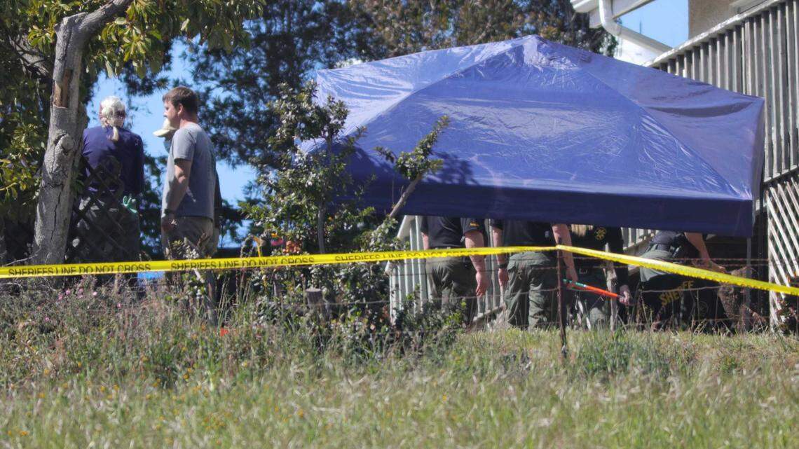 Investigators under a blue shade tent outside the Arroyo Grande home of Ruben Flores on Tuesday, March 16, 2021, as the San Luis Obispo County Sheriff’s Office searches the property for a second day. Flores is the father of Paul Flores, now considered the prime suspect in missing Cal Poly student Kristin Smart’s disappearance.