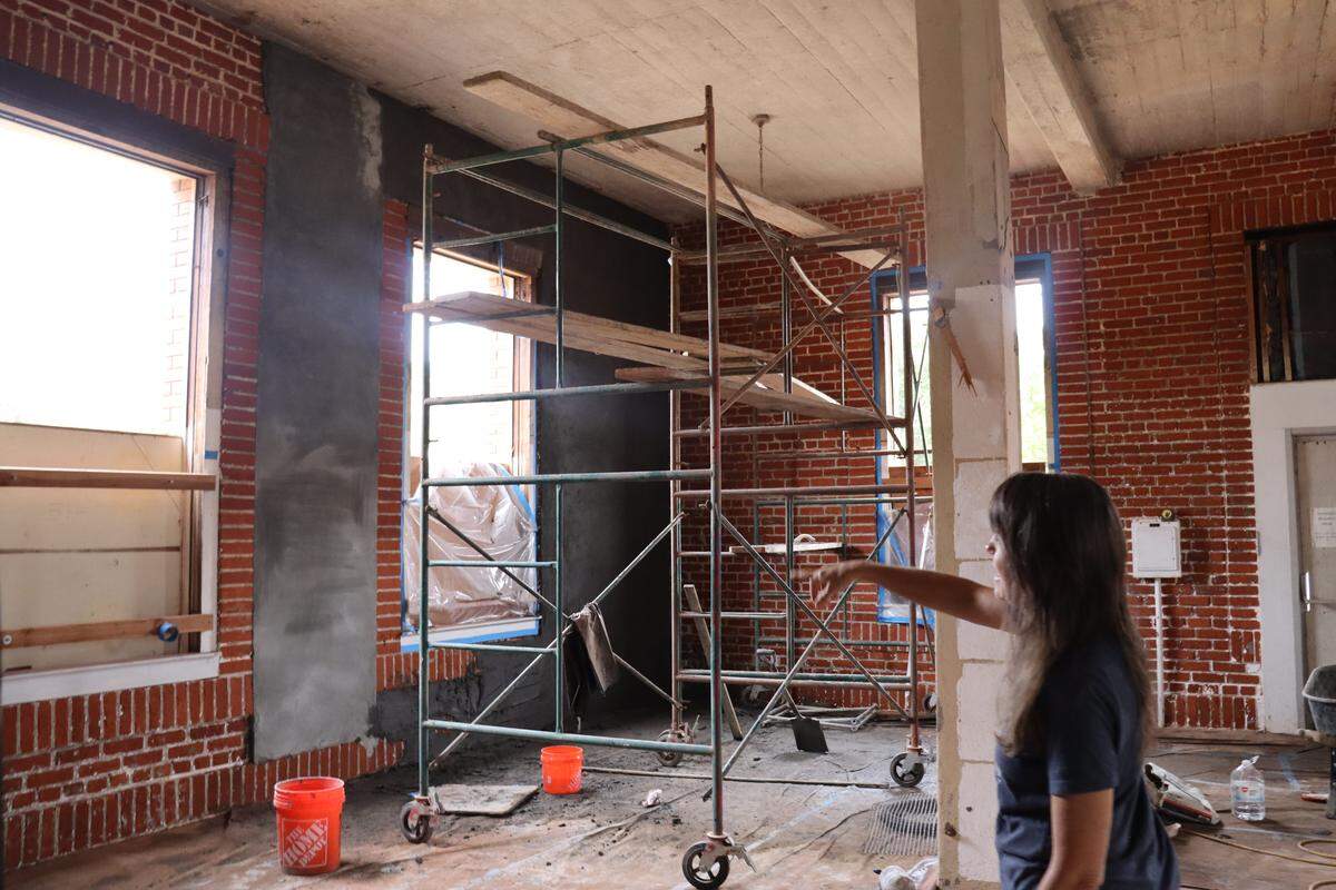 President of the Atascadero Printery Foundation Karen McNamara points to the retrofitting and plastering of the Atascadero Printery’s walls. With renovations underway, the printery will open to the public for the first time in over two decades for free tours. See the building’s progress on Saturday, Sept. 20., 2025.