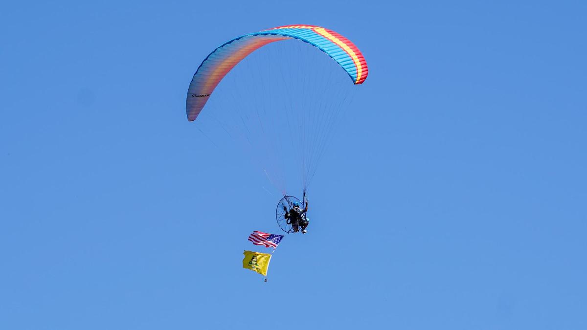 A paramotor pilot flies over the Templeton Fourth of July Parade Thursday, July 4, 2024. The parade featured dozens of floats and acts, including classic cars, marching bands and appearances by local law enforcement and fire services.