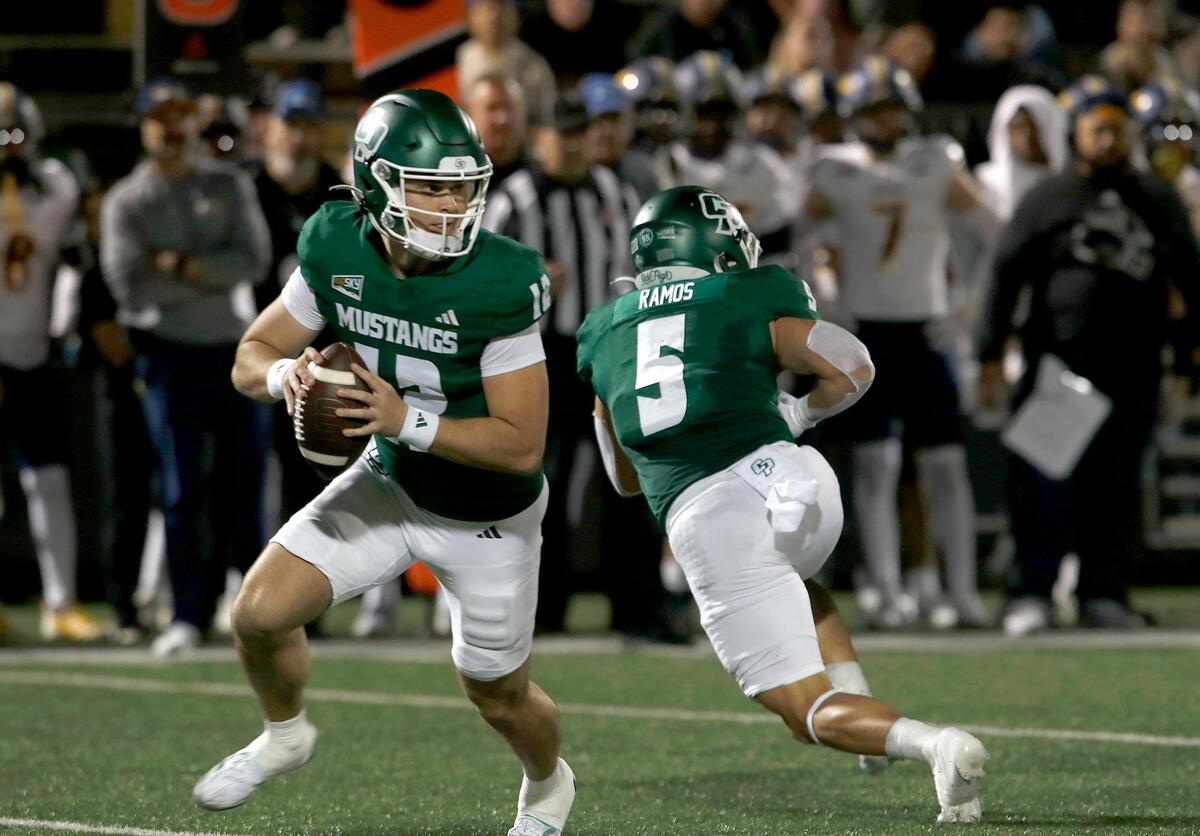 Cal Poly quarterback Jackson Akins looks for a receiver. Cal Poly lost to Northern Arizona 31–14 in a college football game at Mustang Memorial Field on Nov. 9, 2024.