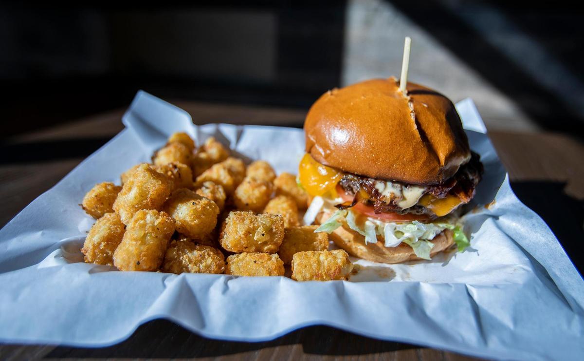 Brooks Burgers recently opened in San Luis Obispo. Pictured is the Bacon Jam Burger, a hamburger on a fresh baked bun topped with bacon jam, Colby-Jack cheese, lettuce, tomato, grilled onion and ‘Boss Sauce’ with tater tots on the side.