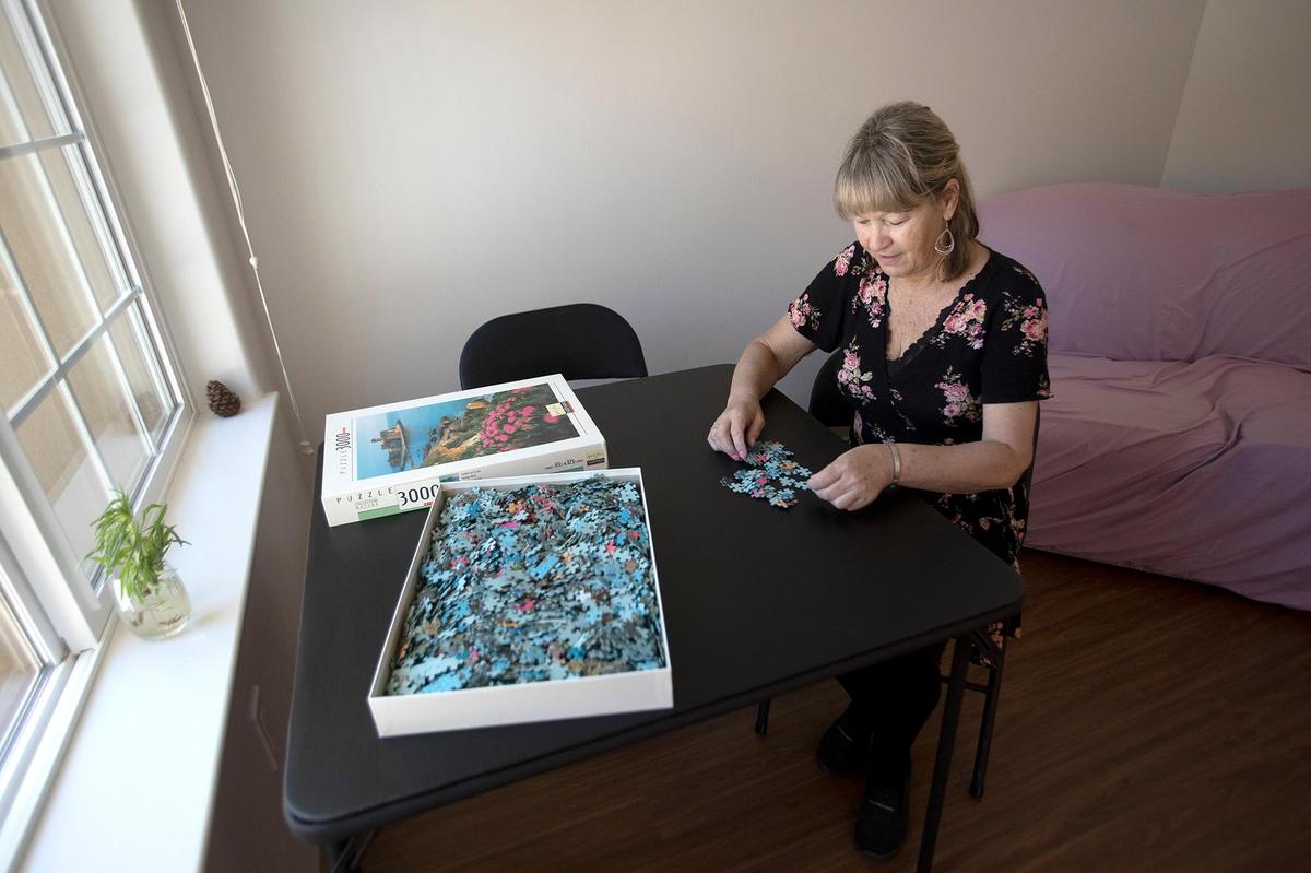 Denise Flores, who was homeless for five years until 2022, recently obtained housing in Templeton in a new senior complex. She bought some puzzles because it relaxes her.