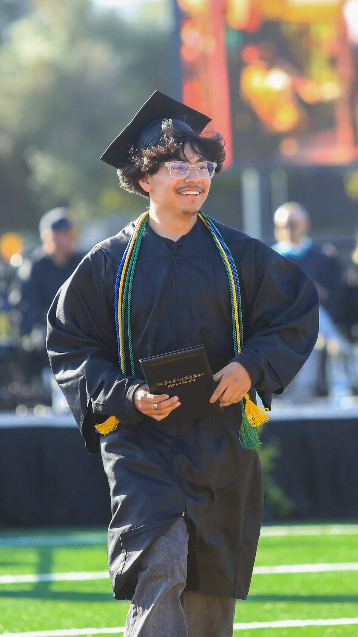 San Luis Obispo High School senior Adrian Puga, who delivered the senior address, receives his diploma during commencement ceremonies at Holt Field on Friday, June 5, 2026. 374 seniors received their diplomas.