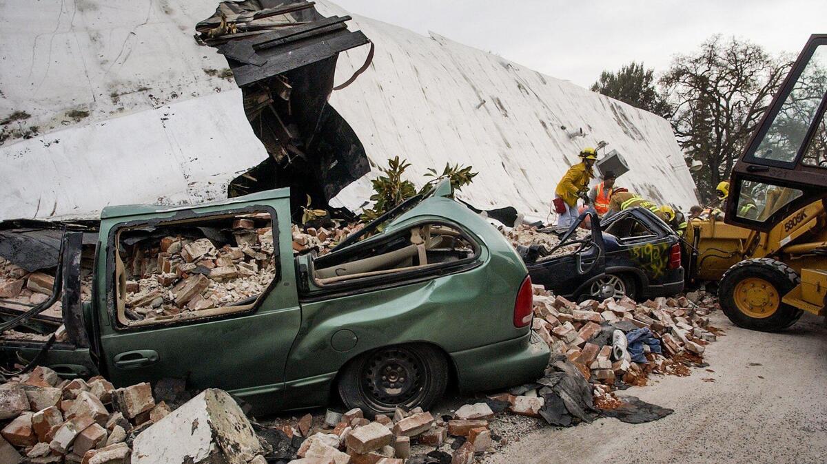 Cars were crushed and two people died on Pine Street in Paso Robles when an unreinforced masonry building collapsed during the San Simeon Earthquake, Dec. 22, 2003.