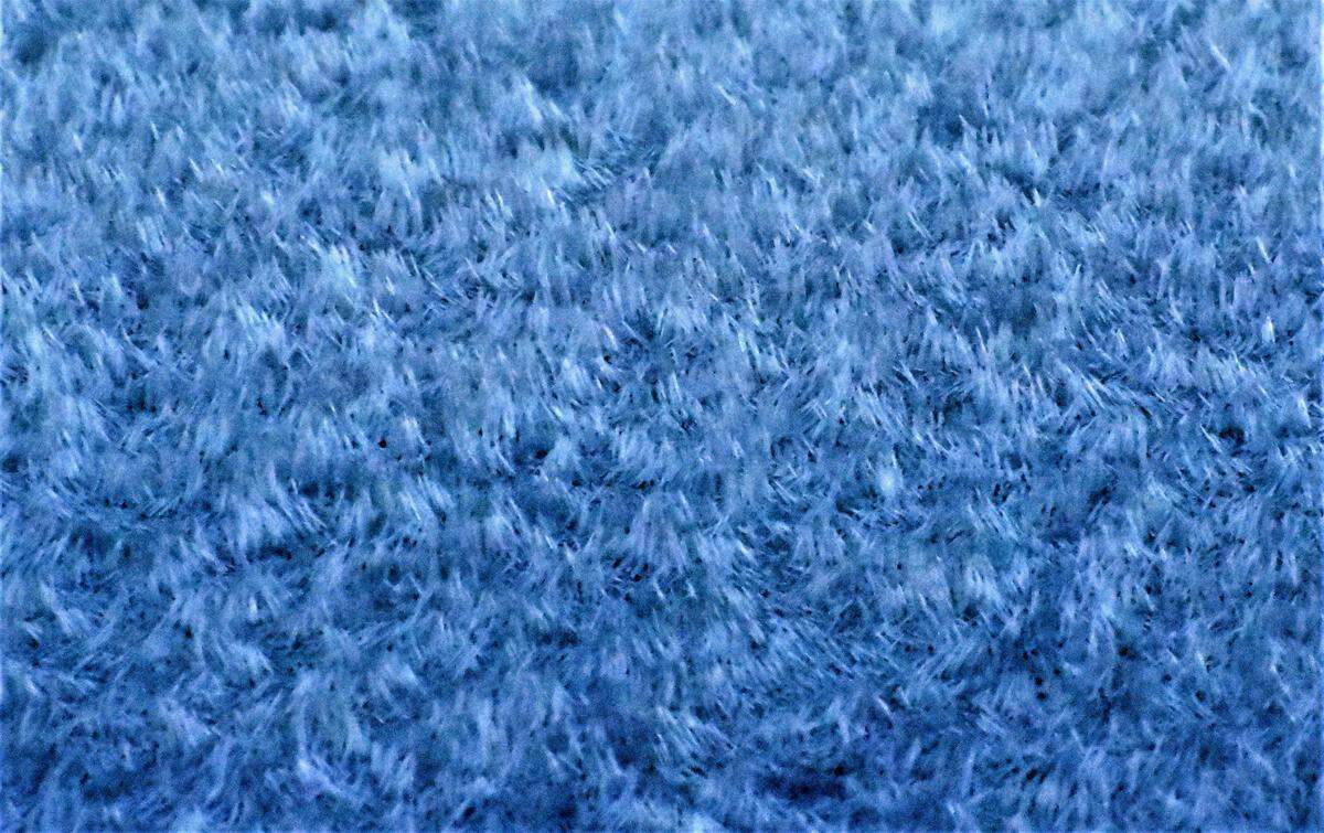 A layer of frost develops on a car windshield.
