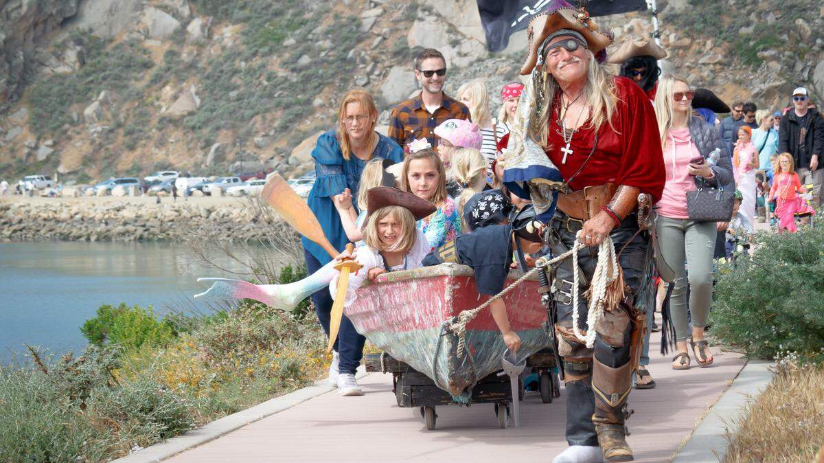 "Pyrate Steve" Yarling, a Morro Bay resident and street performer, gives kids a ride in his skiff on the bike path in Morro Bay. The skiff was stolen after this year's Fourth of July Parade in Cayucos.