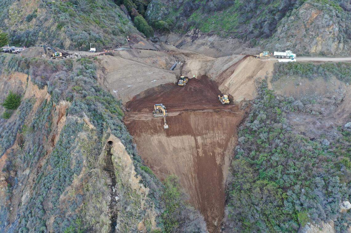 Crews fill in dirt at the site of the Rat Creek slide on Highway 1 near Big Sur.