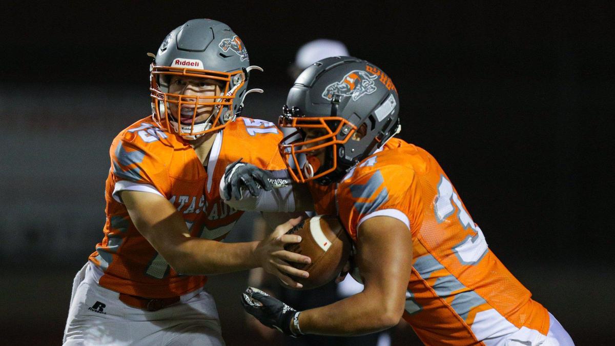 Kane Cooks hands off to his brother, Trey Cooks during Atascadero’s 27-21 win over Templeton in an Ocean League football game on Oct. 7, 2022.