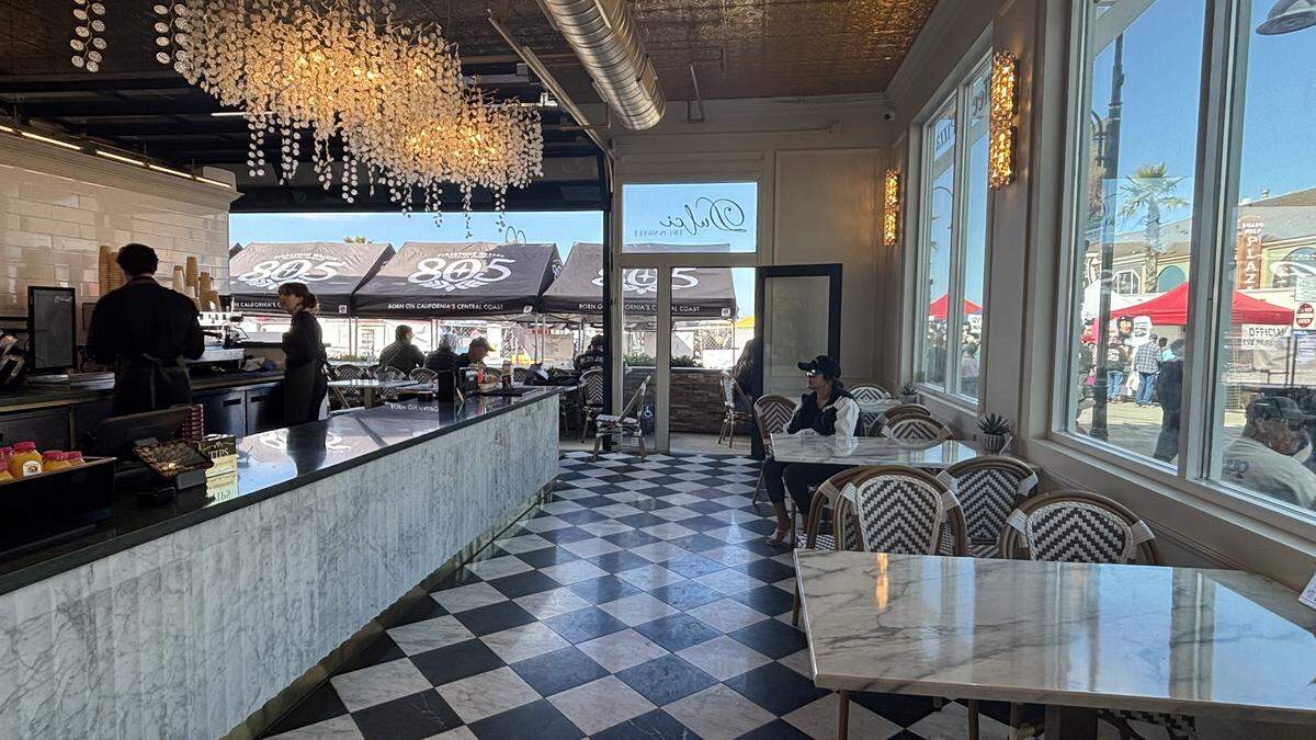 Dulci Coffee in Pismo Beach has checkered flooring, golden chandelier-styled lighting, bistro chairs and marbled tables.